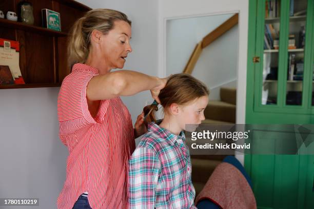 a mother styling her daughters hair - older woman colored hair stock pictures, royalty-free photos & images