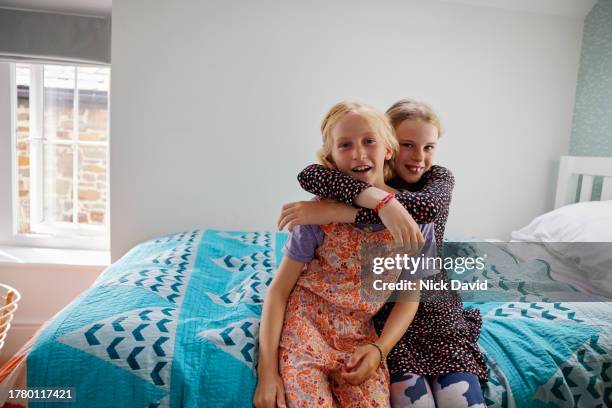 portrait of two girls together at home in their bedroom - budding tween stock pictures, royalty-free photos & images