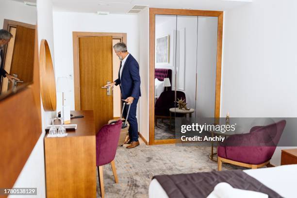 elegantly dressed businessman comes into his hotel room - keycard access stock pictures, royalty-free photos & images