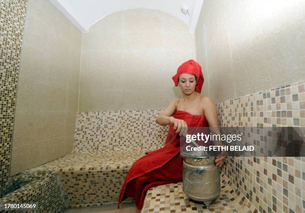 Woman enjoys her spa treatment "Boulbaba", one of the most famous beauty centres in Tunis, on May 13, 2011. Because of the city's nightly curfew,...