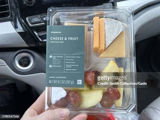 Person's hand holding a Starbucks Cheese and Fruit box in a car in Lafayette, California, January 14, 2023.