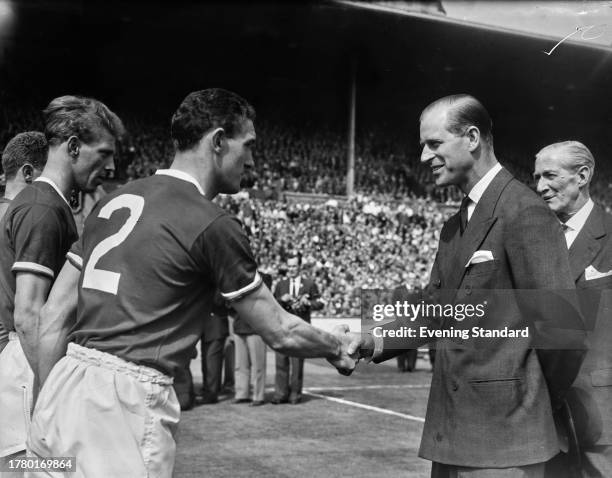 The Duke of Edinburgh shaking hands with Bill Foulkes , captain of Manchester United FC, ahead of the FA Cup Final at Wembley Stadium in London, May...