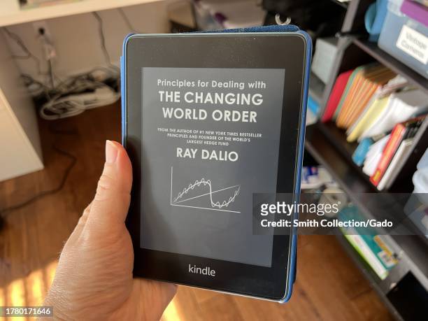 Person's hand holding an Amazon Kindle device displaying an advertisement, Lafayette, California, February 8, 2023.