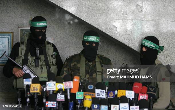 Masked Palestinian Hamas militants attend a press briefing in Gaza City, on March 2, 2008 during which they gave details of the battle against...