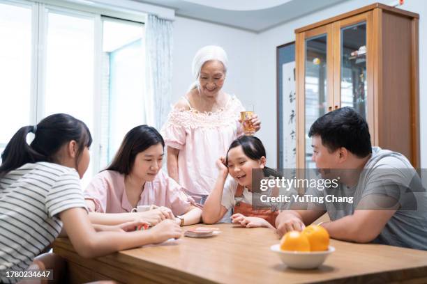 the three generations family board game time - yuting stock pictures, royalty-free photos & images