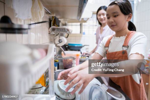 girl washing the dishes - yuting stock pictures, royalty-free photos & images