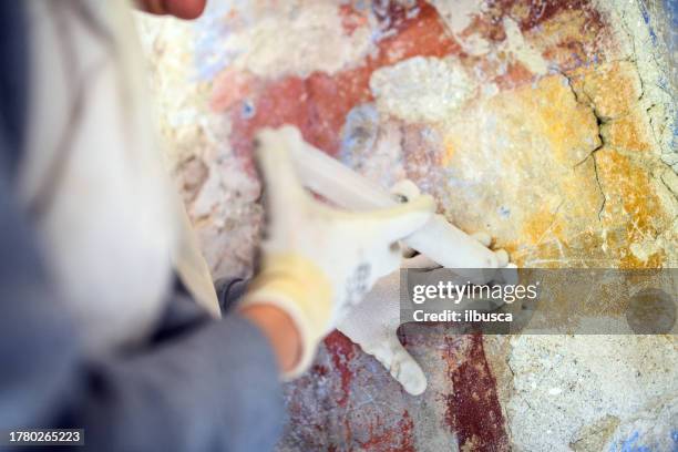 professional restorer restoring antique chapel fresco in italy - vintage syringe stock pictures, royalty-free photos & images