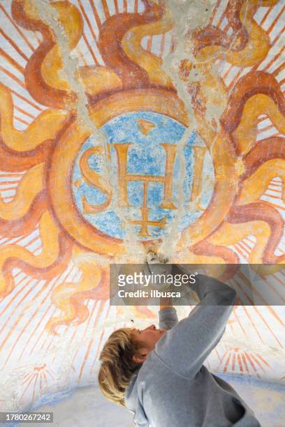 professional restorer restoring antique chapel fresco in italy - vintage syringe stock pictures, royalty-free photos & images