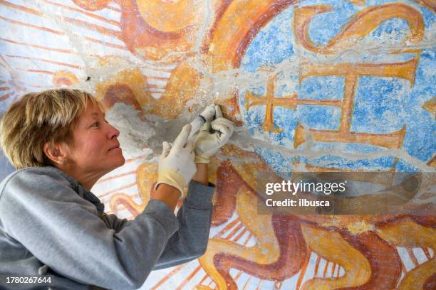 professional restorer restoring antique chapel fresco in italy - vintage syringe stock pictures, royalty-free photos & images