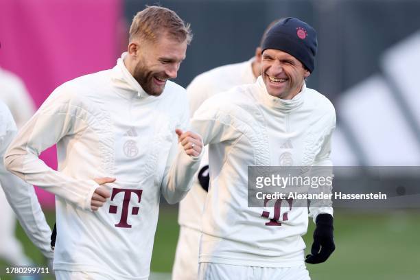 Thomas Müller of FC Bayern Munich jokes with his team mate Konrad Laimer during a FC Bayern München training session at Bayern's training ground...