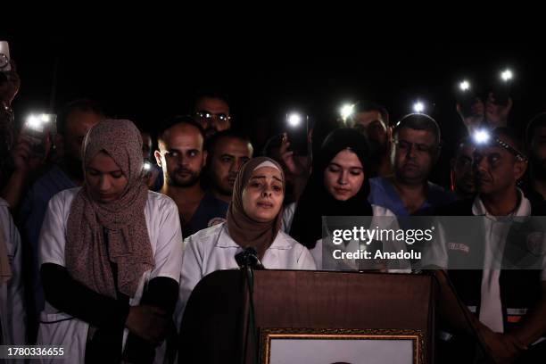 Healthcare workers at the Nassr Hospital gather to show support for their colleagues who continue their duties with limited resources and under...