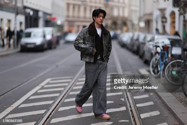Bao Tran seen wearing Diesel grey/black distressed leather pilot jacket, COS brown wool knit cardigan jacket, Weekday white cotton t-shirt, Calvin...