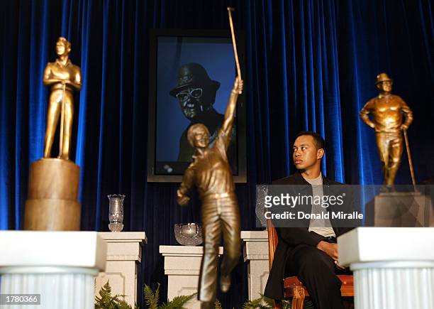 Tiger Woods looks on amidst the Arnold Palmer, Jack Nicklaus and Byron Nelson Awards Trophies all of which he won during the PGA Awards Ceremony for...