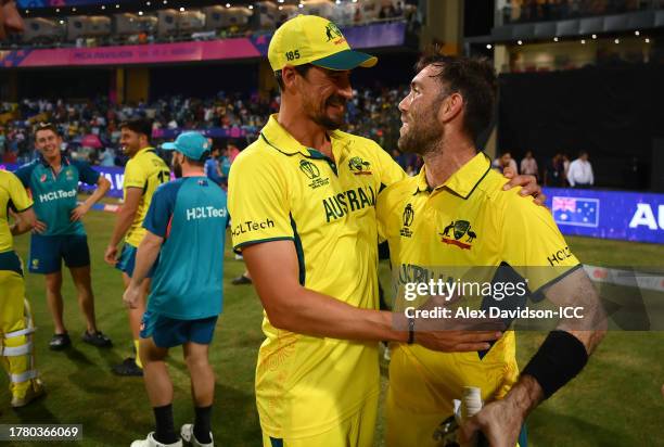 Mitchell Starc and Glenn Maxwell of Australia celebrate following the ICC Men's Cricket World Cup India 2023 between Australia and Afghanistan at...