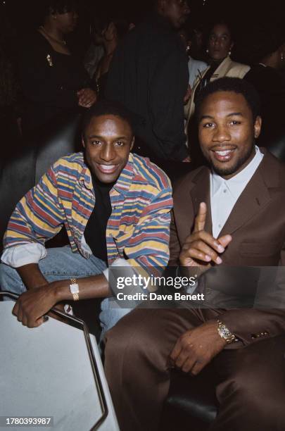 British professional footballer John Fashanu and British-Canadian boxer Lennox Lewis at Stringfellows club, London, June 1994.