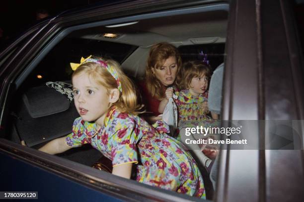 Sarah, Duchess of York with her daughters Princess Eugenie and Princess Beatrice outside Planet Hollywood in London, 21st December 1993.