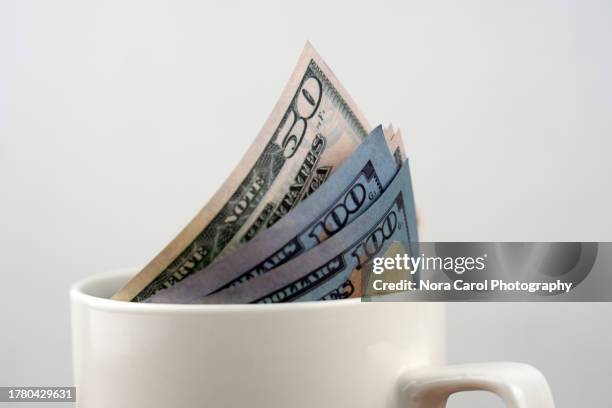 close up paper currency in a mug - gratitude jar stock pictures, royalty-free photos & images