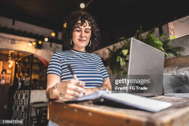 receptionist working on a restaurant of hotel boutique - front desk laptop stock pictures, royalty-free photos & images