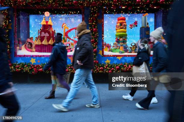 Shoppers walk past holiday window displays at the Macy's Inc. Flagship store in the Herald Square area of New York, US, on Monday, Nov. 13, 2023. US...