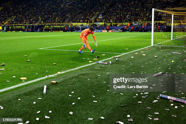 Gregor Kobel of Borussia Dortmund looks on as fake money is seen on the pitch during the UEFA Champions League match between Borussia Dortmund and...