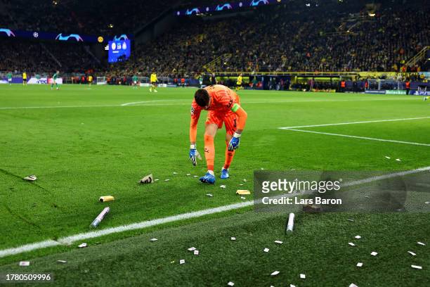 Gregor Kobel of Borussia Dortmund looks on as fake money is seen on the pitch during the UEFA Champions League match between Borussia Dortmund and...