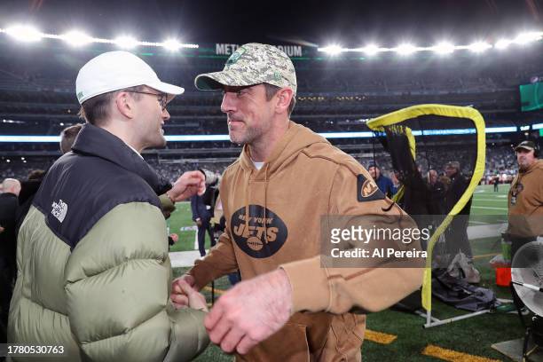 Quarterback Aaron Rodgers of the New York Jets meets with Hugh Coles on the sideline of the Los Angeles Chargers vs New York Jets Monday Night...