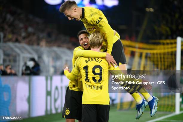 Julian Brandt of Dortmund celebrates after scoring his team's second goal with Nico Schlotterbeck and Felix Nmecha during the UEFA Champions League...
