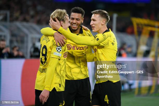 Julian Brandt of Dortmund celebrates after scoring his team's second goal with Nico Schlotterbeck and Felix Nmecha during the UEFA Champions League...