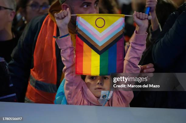 Young girl holds a flag with the rainbow and transgender colors during a protest to defend LGBTIQ rights. Thousands of people have gathered in Puerta...