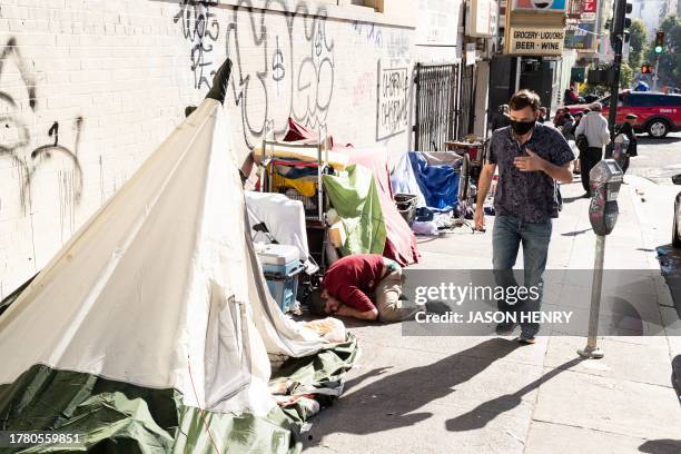 People and their belongings are seen on Jones Street in San Francisco, on November 13, 2023. San Francisco has struggled to clean up the city ahead...