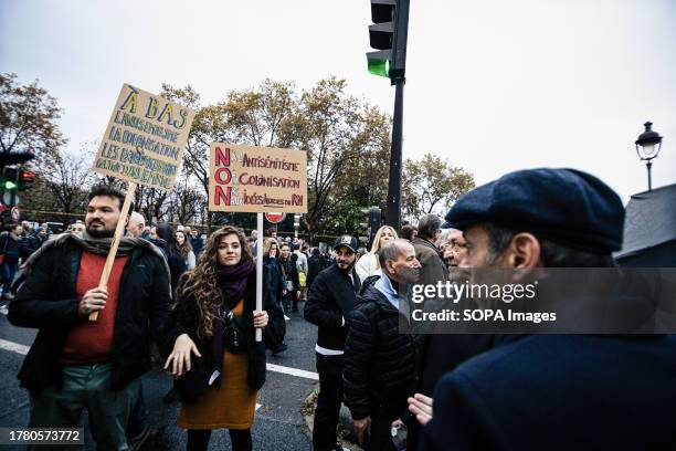 Protester questions a couple of protesters for their placards during the demonstration against antisemitism. Demonstrations against antisemitism took...
