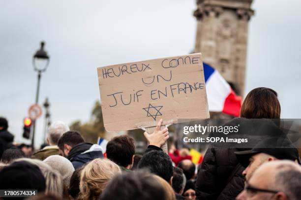 Protester holds a placard that says "Happy as a Jewish in France" during the demonstration against antisemitism. Demonstrations against antisemitism...