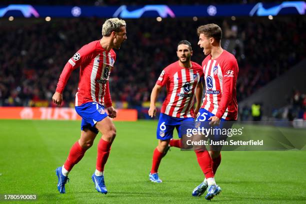 Antoine Griezmann of Atletico Madrid celebrates with teammate Rodrigo Riquelme after scoring the team's first goal during the UEFA Champions League...