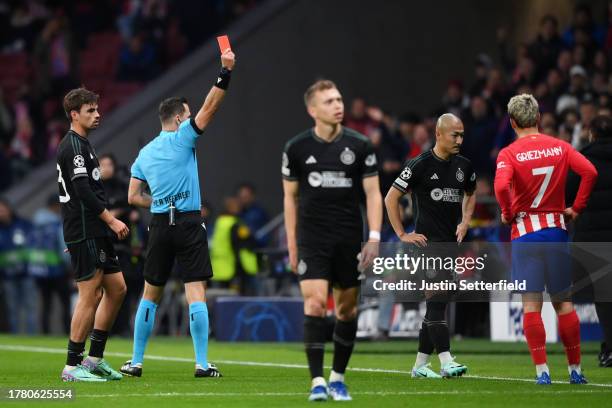 Referee Ivan Kruzliak shows a red card to Daizen Maeda of Celtic during the UEFA Champions League match between Atletico Madrid and Celtic FC at...