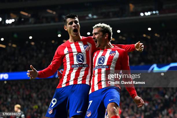 Antoine Griezmann of Atletico Madrid celebrates with teammate Alvaro Morata after scoring the team's third goal during the UEFA Champions League...