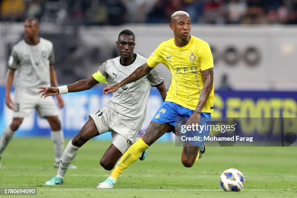 Almoez Ali of Al Duhail competes for the ball with Talisca of Al-Nassr during AFC Champions League match between Al Duhail and Al-Nassr at Khalifa...