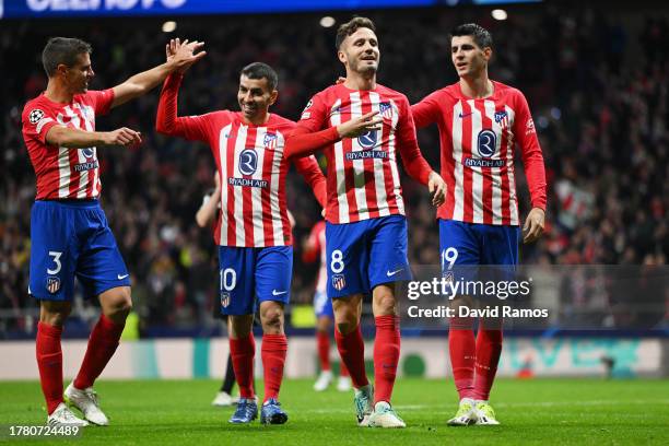 Saul Niguez of Atletico Madrid celebrates with teammates after scoring the team's sixth goal during the UEFA Champions League match between Atletico...