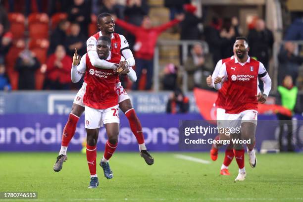 Christ Tiehi of Rotherham United celebrates with teammate Hakeem Odoffin after scoring the team's second goal during the Sky Bet Championship match...