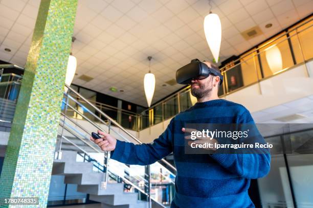 worker in the office with vr glasses, cyberspace experience at work. concentrated office worker touching objects in digital world, businessman in 3d glasses interacting with virtual reality - cyberspace stock pictures, royalty-free photos & images