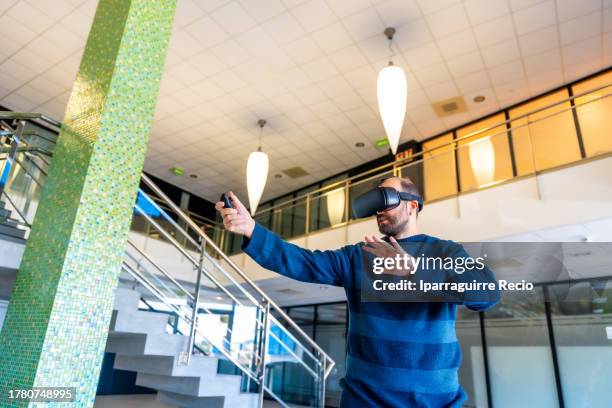 worker in the office with vr glasses, cyberspace experience at work. an office worker touching objects in the digital world, a businessman with 3d glasses interacting with virtual reality - cyberspace stock pictures, royalty-free photos & images