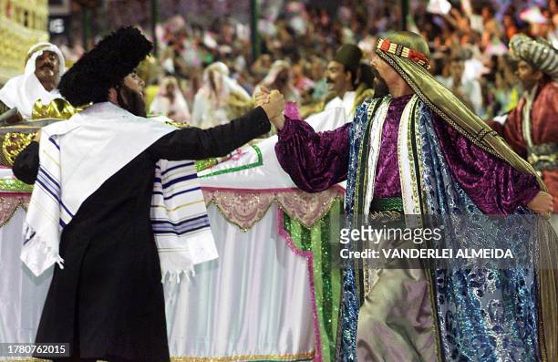 Carlinhos de Jesus , dressed as an Arab, holds the hand of a man dressed as an ultra Orthodox Jew both are of the Mangueira samba school 27 February...