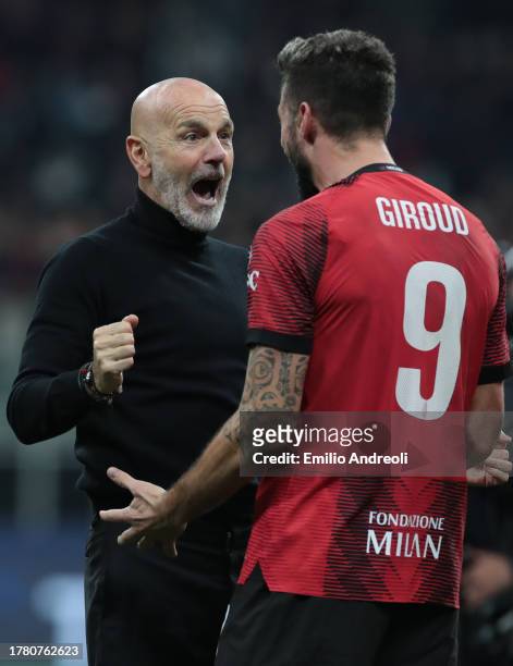 Milan coach Stefano Pioli celebrates victory with Olivier Giroud following the UEFA Champions League match between AC Milan and Paris Saint-Germain...