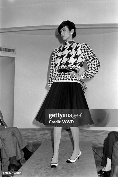 Model Anna Moll Moers presents an ensemble from the spring 1985 ready to wear collection inside of designer Pauline Trigère's New York City showroom.