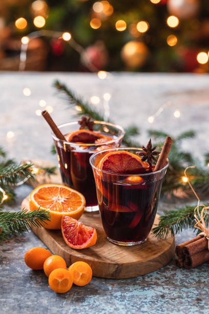 hot mulled wine with spices for christmas - orange cocktail stock pictures, royalty-free photos & images