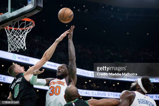 Julius Randle of the New York Knicks drives to the basket against Kristaps Porzingis of the Boston Celtics during the first quarter at TD Garden on...
