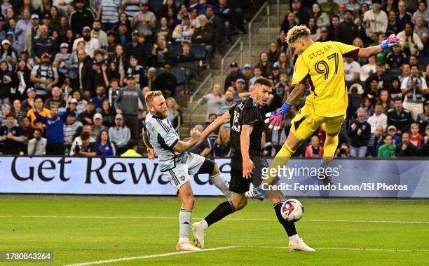 Johnny Russell of Sporting Kansas City scores past Michael Boxall and Dayne St. Clair of Minnesota United during a game between Minnesota United FC...