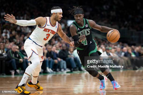 Jrue Holiday of the Boston Celtics drives to the basket against Josh Hart of the New York Knicks during the second half at TD Garden on November 13,...