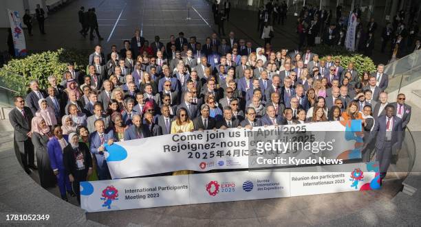 Attendees pose for a photo on the first day of a two-day international conference on the Osaka expo in Osaka on Nov. 14, 2023. The Japan Association...