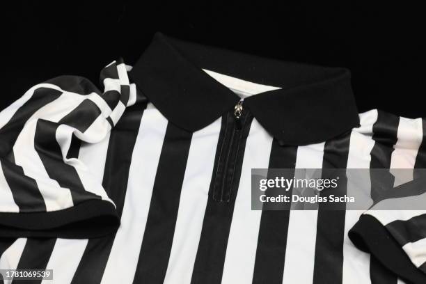 sports referee jersey on a black background - collar stock pictures, royalty-free photos & images