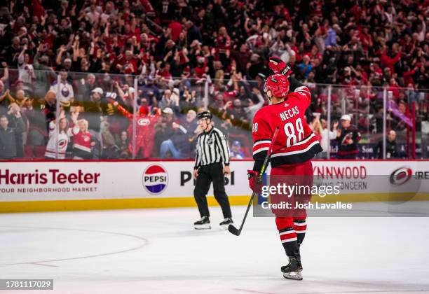 Martin Necas of the Carolina Hurricanes celebrates after scoring the game-winning goal in overtime against the Buffalo Sabres at PNC Arena on...